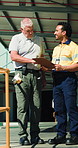 Clipboard, logistics and planning with men outdoor together for delivery or shipping management. Meeting, paperwork and teamwork with happy supply chain people at distribution plant for conversation