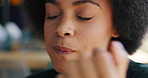 Happy, woman and eating donut in bakery with delicious taste, fast food and satisfied sugar craving. African person, smile and hungry in cafe for dessert, sweet treats and snack with unhealthy diet.