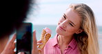 Influencer, phone screen and friends at beach with ice cream, happy or digital memory on summer vacation. Smile, post or people with cone, social media update or content creation on seaside trip.