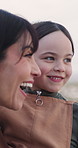 Mother, kid and talking on vacation with view, funny joke and sightseeing while carrying daughter. Mom, girl and conversation on holiday, waving and laughing together with happy family outdoor