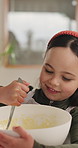 Happy, child and baking in kitchen with mixture, bowl and meal preparation for skill development. Girl, kid smile and food ingredients in house with dessert recipe, learning or independent for growth