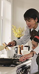 Mom, child and cooking in kitchen with pancake, meal preparation and excited for bonding together. Woman, daughter and happy in home with breakfast food recipe, help and learning skills for growth.