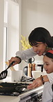 Mom, daughter and cooking in kitchen with pancake, meal preparation and smile for bonding together. Woman, child and happy in house with breakfast food recipe, help and learning skills for growth.