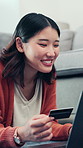 Happy, asian woman and credit card with laptop in home for online shopping, payment or purchase. Female person, user or shopper with smile, debit or computer for wireless transaction or banking app