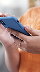 Hands, phone and scroll with app in home on web, chat and communication with online dating. Person, smartphone and click with mobile network, post or notification with social media at apartment