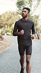 Running, mountain and man with earphones for fitness, exercise and cardio workout for health. Athlete, runner and person with music, audio and radio for training, endurance and active hobby on road