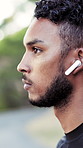 Thinking, nature and man with earphones for fitness, training and exercise for wellness, health or cardio. Runner, athlete and profile of person with audio, podcast and music for active hobby outdoor