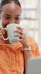 Woman, laptop and drinking coffee in home with remote work, smile or article submission for journalism. Happy, black person and freelance writer in house with computer, tea or typing for news report.