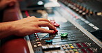 Mixing, hands and sound engineer in music studio with equipment, change volume and album production. Man, audio technician and creativity with technology for editing track, project and record label.