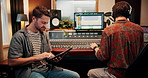 Production, tablet and producers in studio with music for working on album or song with computer. DJ, equipment and male sound technicians with technology for mixing audio track in recording booth.