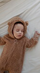 Development, sleeping and peace with baby in nursery of home for growth, nap time or quiet. Asleep, children and dreaming with infant boy in bear onesie for break, comfort or rest from above