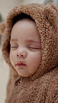 Asleep, development and quiet with baby in nursery of home for dreaming, growth or peace. Children, nap time and sleeping with infant boy in bear onesie for break, comfort or rest at apartment