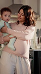 Love, pregnant woman and baby with support in kitchen, soothing infant and connection for security. Childcare, rocking and happy mother with boy in home, future sibling or attention for family growth