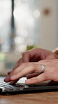 Hands, laptop and typing with person at desk in home for development, planning or research. Fingers, keyboard and remote work with freelance man at table in apartment for administration or review