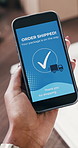 Hands, person and phone screen with notification in warehouse for ecommerce or order shipping. Closeup, mobile app or confirmation of delivery alert, tracking package or verification for distribution
