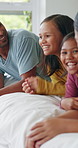 Smile, parents and relax with children in bedroom for peace, calm morning and bonding together. Happy, people and laughing with kids for weekend break, family connection and comfortable for wellness
