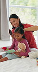 Hairbrush, mother and reading book with girl in bedroom, morning routine and childcare for bonding. Speaking, happy woman and child with hair care for grooming, home and fairytale for learning