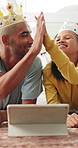 Happy man, high five and child with tablet in house, laugh and role play with girl for fantasy movie. Family, dad and daughter with toy crowns for film, home and celebration for favorite scene on web