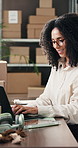Boxes, laptop and smile with woman in logistics plant for management of shipping schedule. Computer, feedback and typing with employee person in supply chain office for delivery or distribution