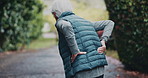 Senior, woman and back pain with fitness injury for workout accident or overworked strain in nature. Elderly, female person or runner with sore spine or joint inflammation for fibromyalgia or tension