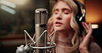 Microphone, singing and woman in booth with headphones for recording music with talent for album. Singer, artist and female musician with audio tech for production on song with media in sound studio.