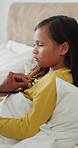 Stethoscope, hand and doctor with child in bed for home consultation, chest pain or flu symptoms. Sick, medical tool and healthcare worker with girl patient for respiratory infection in bedroom.