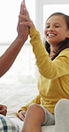 Injury, dad and child high five for plaster in home for first aid, healing support and wound care. Motivation, happy kid or father with leg bandage on bed for bruise protection, healthcare or bravery