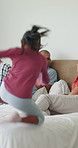 Family, children and jump for fun in bedroom with energy, playful morning and bonding together. People, laughing and kids running to wake up parents, weekend break and excited with holiday activity