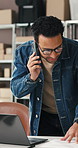 Laptop, documents and man with phone call in logistics for shipping, pricing enquiry or update. Small business, owner or contact client in warehouse for delivery invoice, online order or confirmation