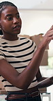 Tablet, clipboard and black woman in office with boxes for delivery, logistics and ecommerce order. Digital technology, documents and African supply chain manager with online shipping information.