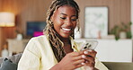 Laugh, typing and black woman in house with phone, online communication and comic post on social media. Happy, digital and person on sofa with tech, funny text message or meme reaction on chat app.
