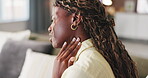 Neck pain, black woman and massage on home sofa for muscle strain, poor posture or stress tension. Female person, rub and living room for osteoarthritis, pinched nerve or burnout on couch in house