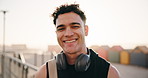 Laugh, fitness and face of man outdoor with headphones for exercise, training and workout for wellness. Happy, runner and portrait of person smile for challenge, health and active hobby in morning