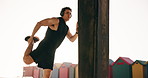 Stretching, training and headphones with man at beach for workout start, health radio and streaming. Warm up, fitness podcast and music with person outdoor for runner, wellness and challenge