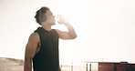 Man, fitness and drinking with water on promenade for outdoor workout, break or recovery. Active, male person or sunshine with mineral liquid or beverage for exercise, rest or training in nature