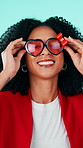 Happy woman, fashion and face with sunglasses for love or valentines day on a studio background. Portrait, female person or model blowing kiss with smile or heart shape shades for romance or date