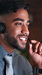 Call center, discussion and man with headset in business, communication or explaining offer at night. Coworking, office and happy person with mic for chat, telemarketing and working late for sales