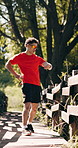 Fitness, man and check smart watch outdoor for running pace, track progress and workout recovery. Tired, runner and monitor timer in nature for cardio break, exercise results and pause on morning jog