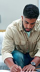 Concern, man and writing with documents in home for finance, budget planning or expenses. Male person, paperwork and analysis with invoices, graph or chart for bills or financial report in house