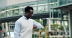 Walking, city and business man with wrist watch in street for morning commute, travel and journey. Pedestrian, corporate and African person check time for work, career and trip to office in town