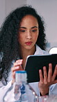 Scientist, woman and research in lab with tablet, vaccine trial and report for medical innovation. Person, typing and review healthcare study in clinic with tech, science website or cure development.