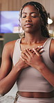 Black woman, breathe and meditate for yoga in home with chakra, inner peace and mindfulness. Female person, yogi or inhale exercise for wellness, spiritual healing and self care with holistic balance