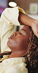 Tired, black woman and relax with breathing at house for peace, calm morning and exhaustion. Female person, eyes closed and exhale with fatigue, weekend break and stress relief from burnout in lounge