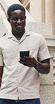 Black man, happy and phone in city for travel with booking for taxi, notification and waiting on sidewalk. African person, smile and typing with mobile app for commute, chat or social media in town