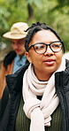 Walking, hiking and woman in forest for travel, thinking and sightseeing on adventure with friends. Trekking, reflection and person outdoor to explore nature, view or vacation for holiday with vision