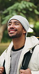 Walking, hiking and man in nature for travel, thinking and sightseeing on adventure with smile. Trekking, reflection and person outdoor to explore forest, happy or tourist on vacation for holiday