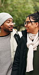 Love, walk or couple in nature with happiness, connection or bonding together on winter break. Laugh, man or woman in park with communication, romantic stroll or healthy relationship in cold season.