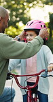 Bike, father or child on road with helmet, bonding together and parent help in summer hobby. Support, bokeh and family in neighborhood with bicycle, learning and connection for motor development.