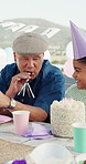 Smile, grandfather and blower with child at birthday party for celebration, gathering and bonding. Happy, old man and blowing horn for outdoor fun, grandchild laughing and support at special occasion