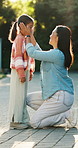 Mother, dressing and kid outdoor for back to school, preparation and morning routine. Woman, helping and daughter for outfit change, getting ready and neat appearance with encouragement for learning